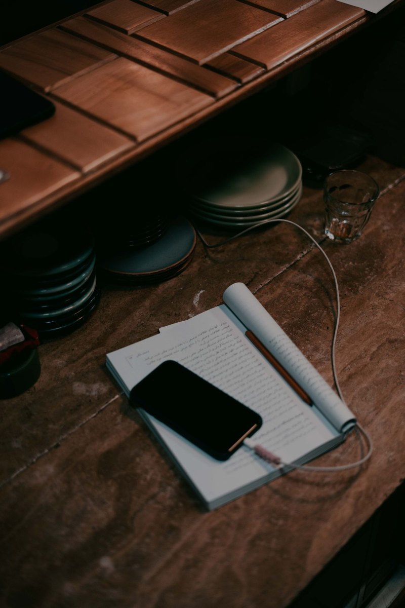Phone charging on an open notebook