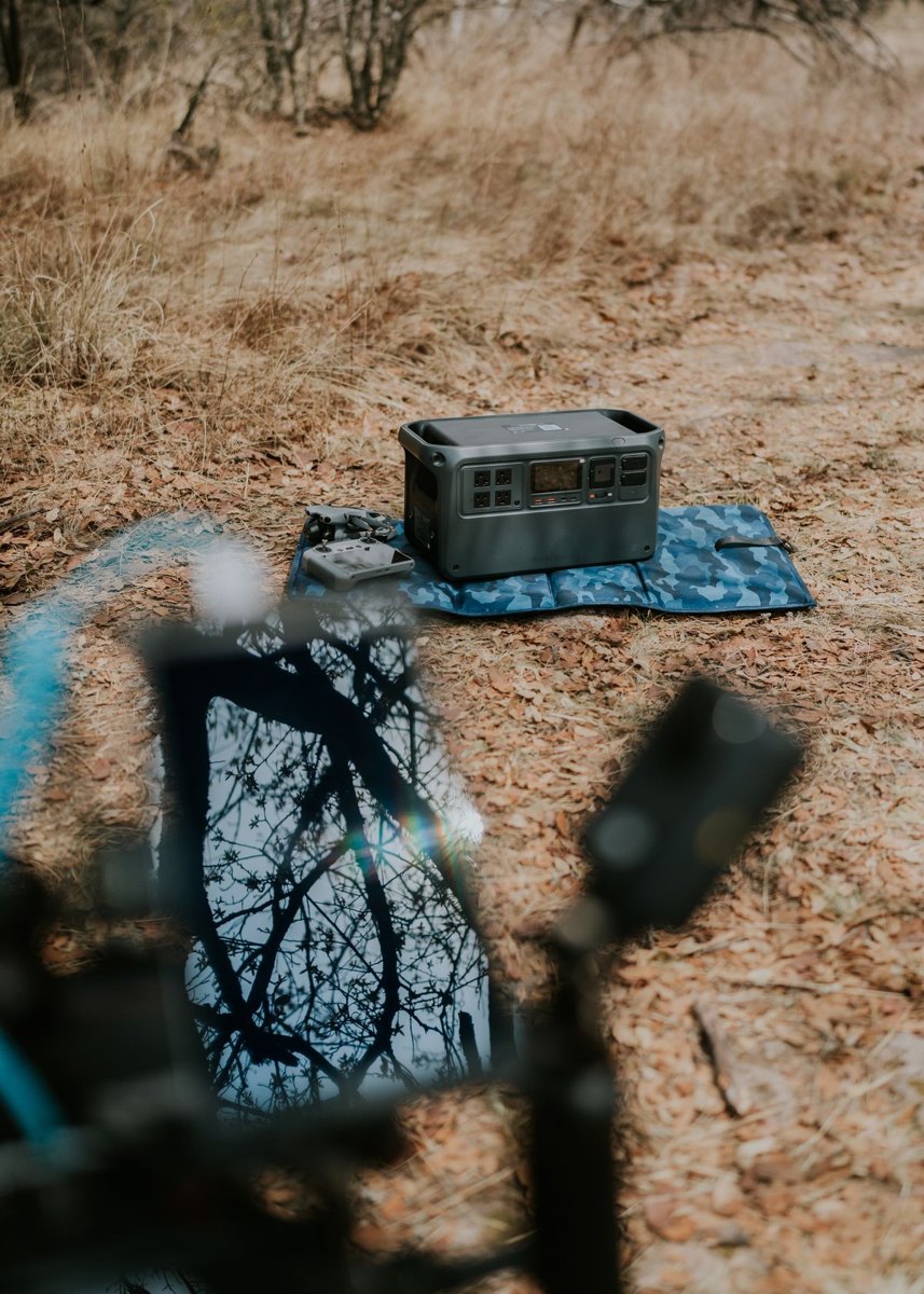 Portable solar panel connected to a battery power station outdoors