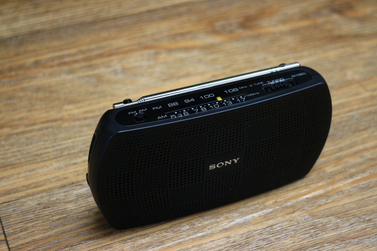 Portable battery radio on a wooden surface