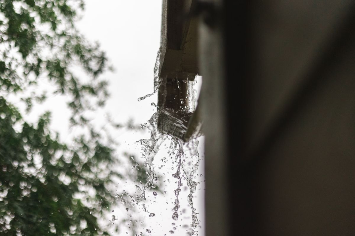 Rainwater flowing from a house gutter