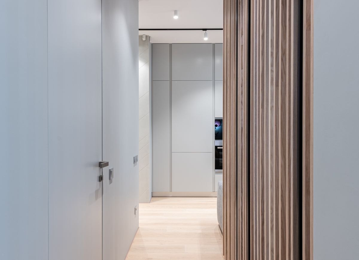 Clear indoor hallway leading toward a doorway