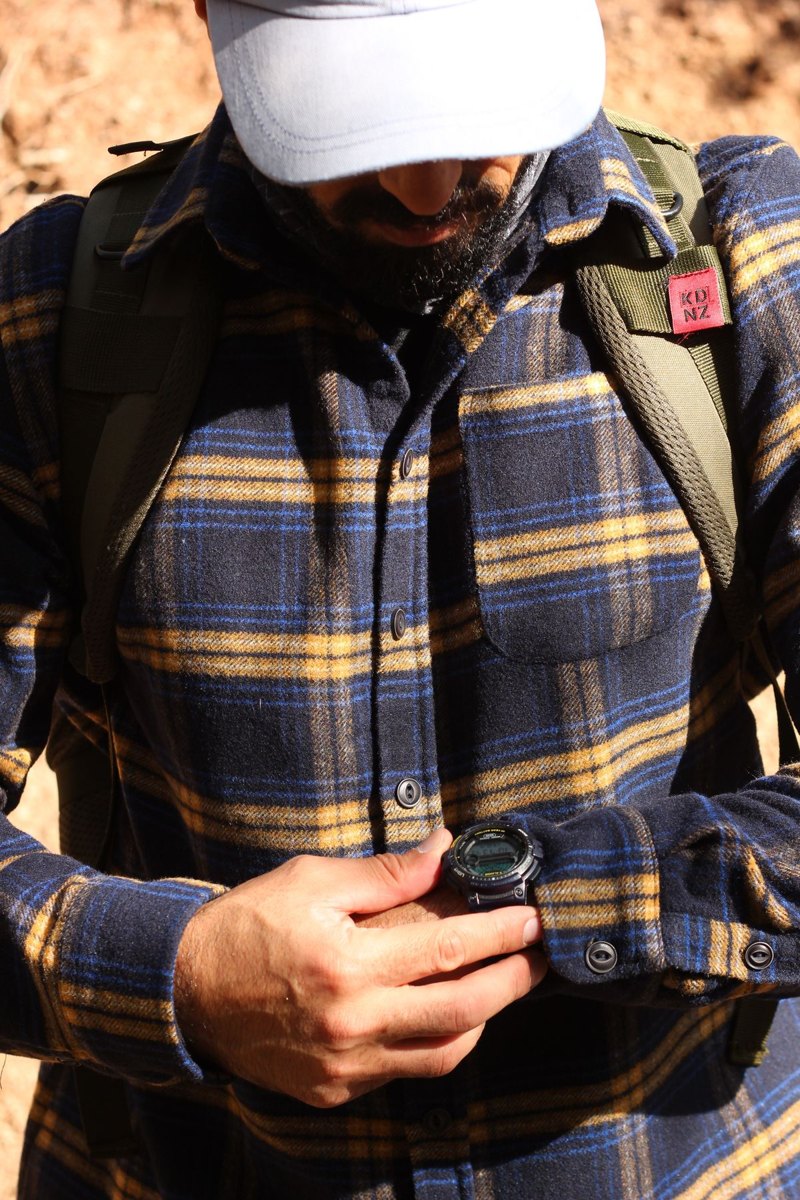 Hiker checking a wristwatch outdoors