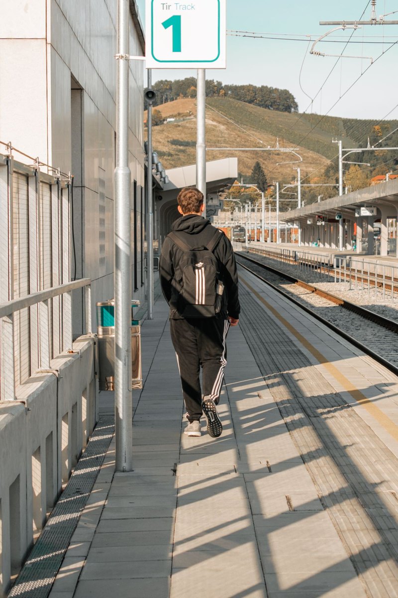 Traveler carrying a backpack through a train station