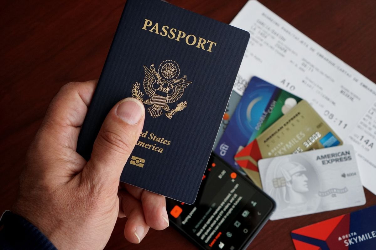 US passport and travel documents beside a phone