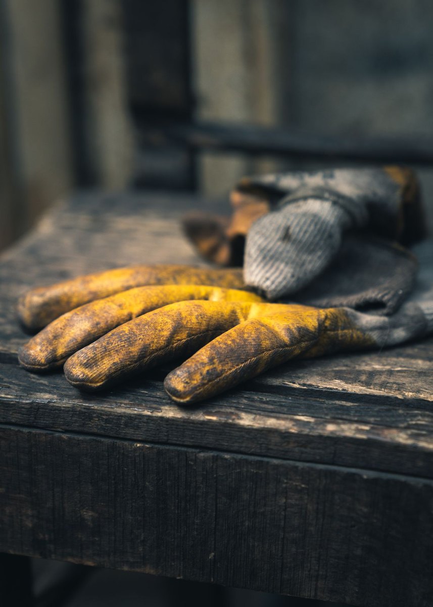 Work gloves resting on a wooden surface
