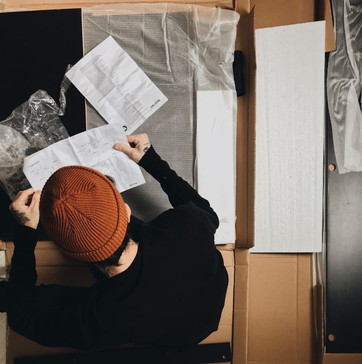 Person reading an instruction booklet before assembly